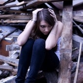 scared-girl-sits-on-ruins-1348272-m