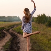 young-girl-dancing-happy-in-a-field-1386580-m